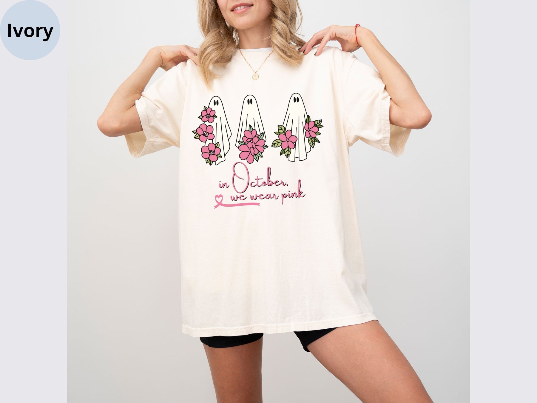 a woman wearing a white shirt with flowers on it