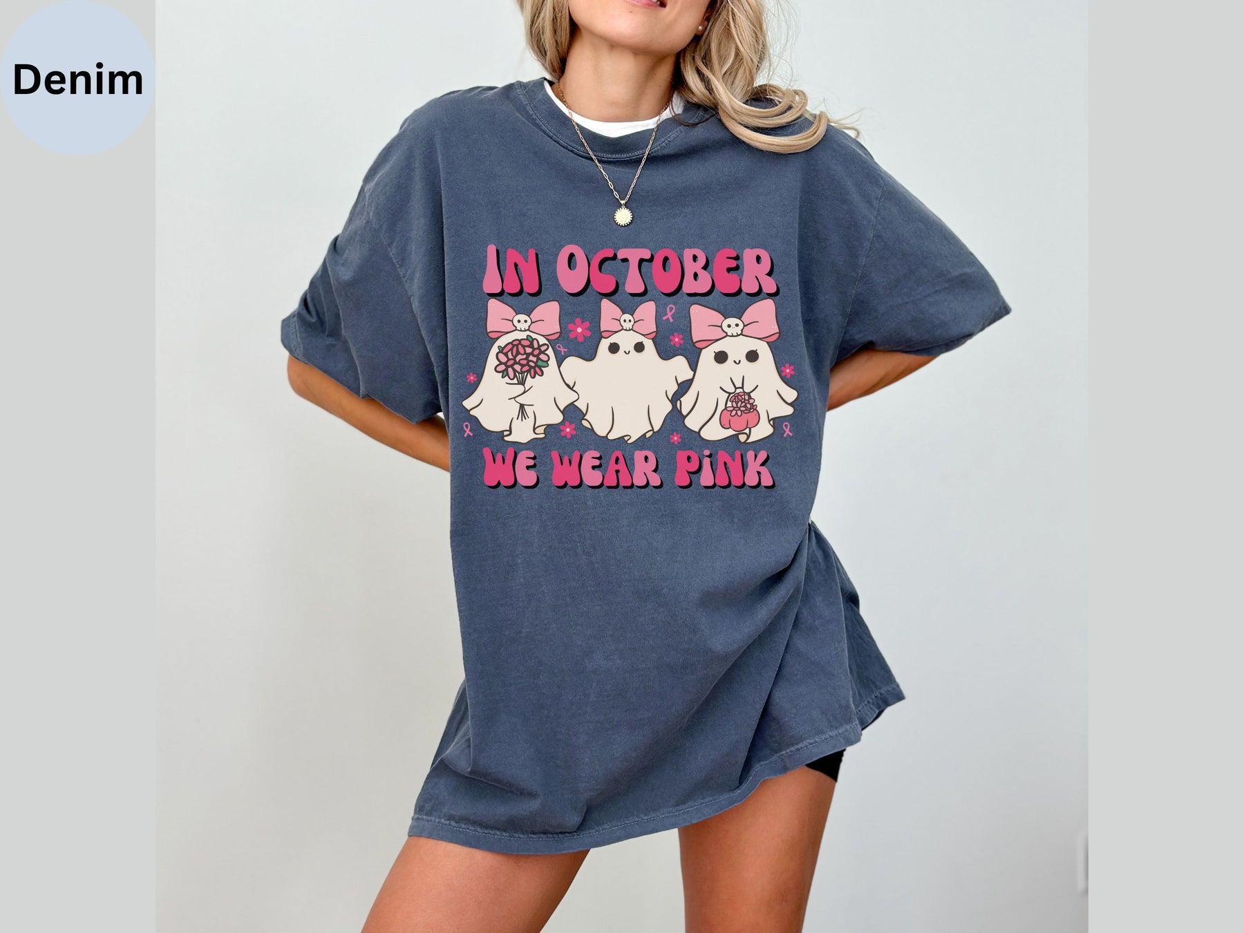 a woman wearing a blue shirt with a picture of two dogs on it