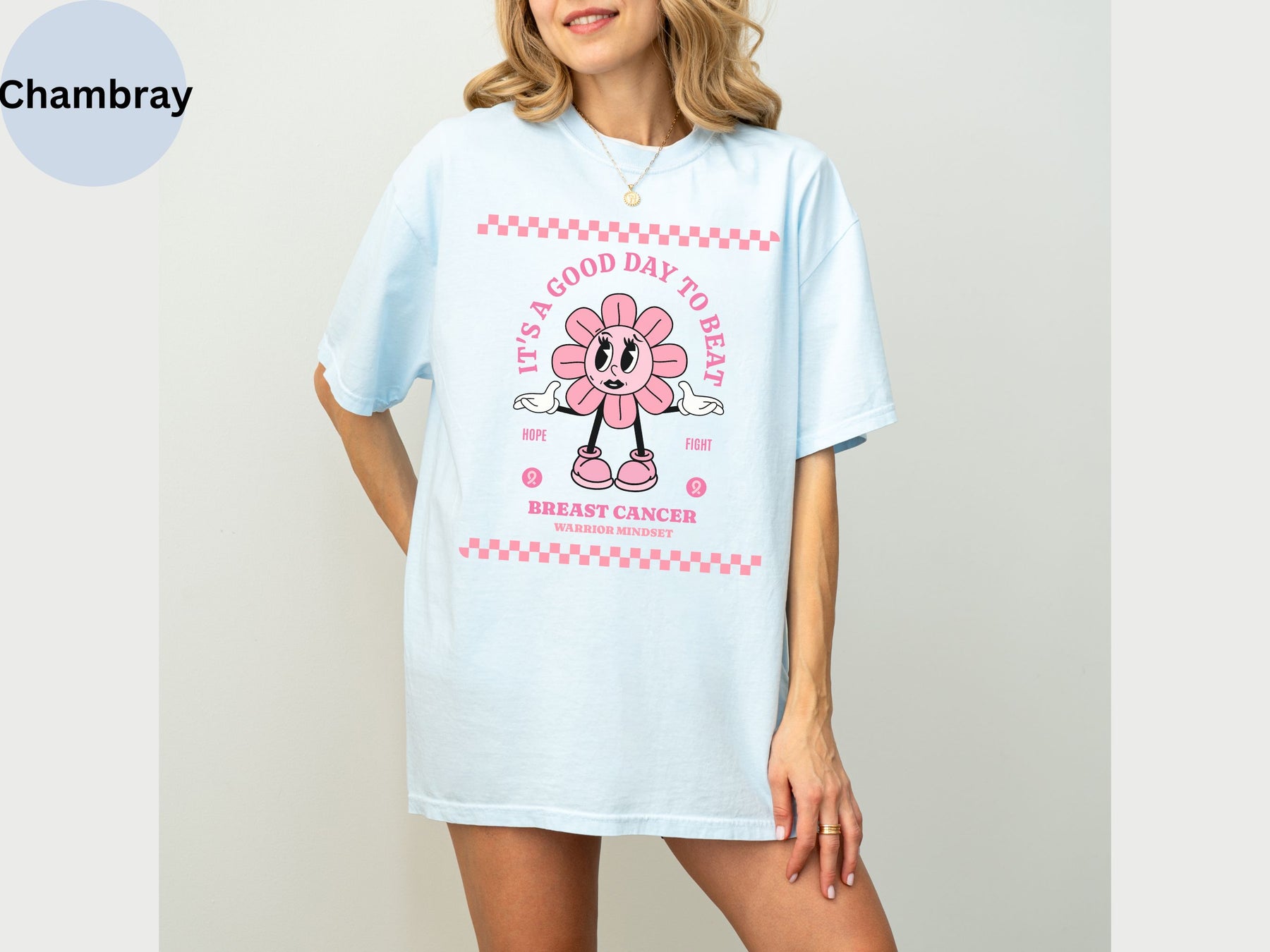 a woman wearing a blue shirt with a pink minnie mouse on it