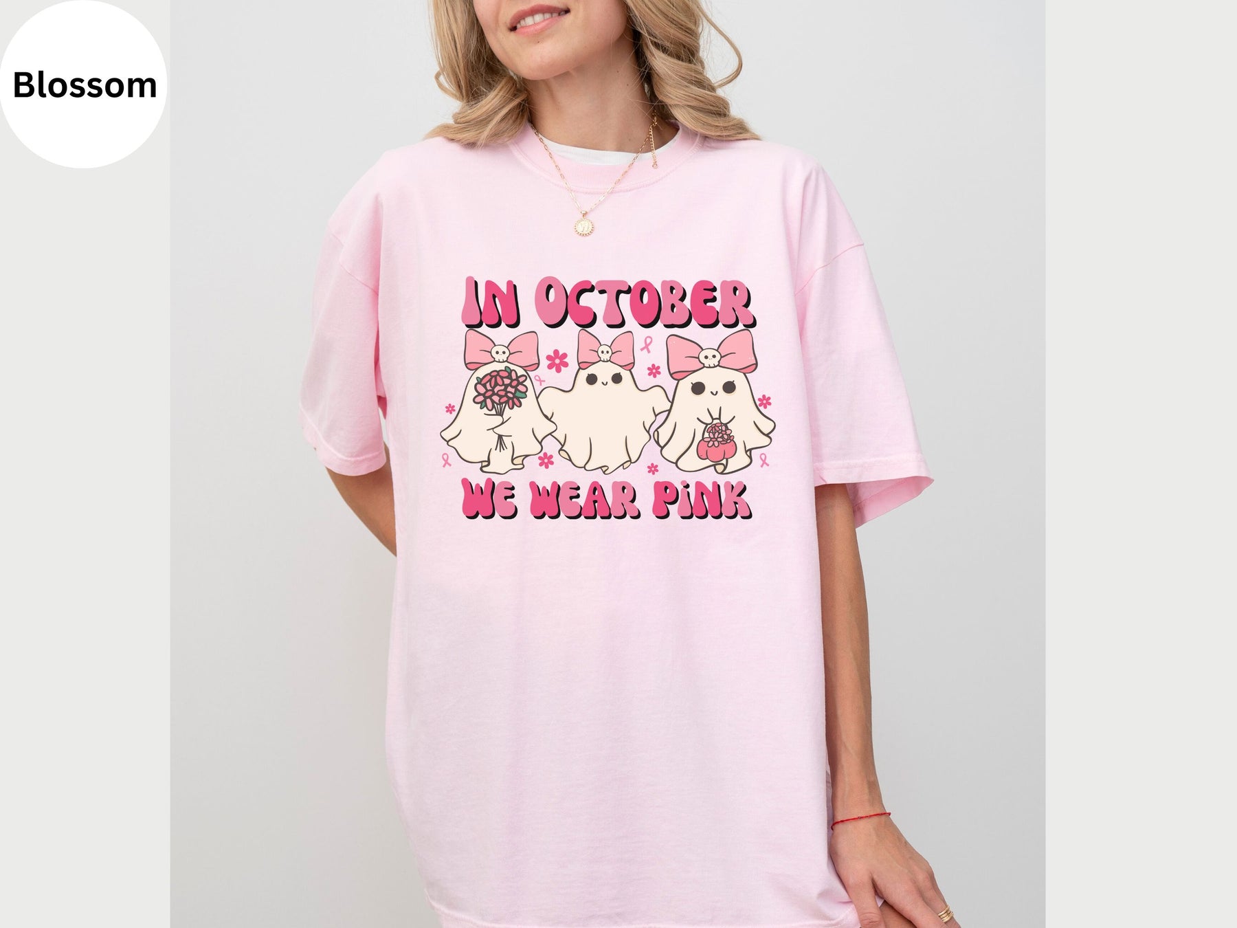 a woman wearing a pink t - shirt that says in october we wear pink