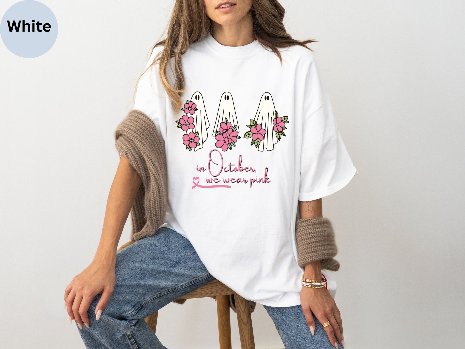 a woman sitting on a chair wearing a white shirt