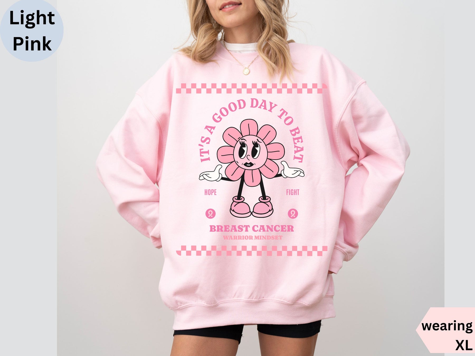 a woman wearing a pink sweatshirt with a cartoon character on it