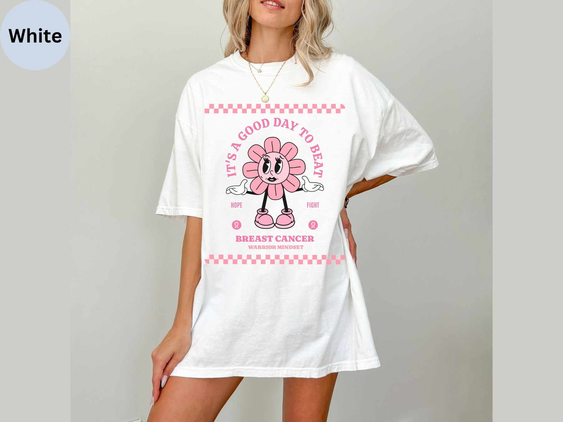 a woman wearing a white t - shirt with a pink flower on it