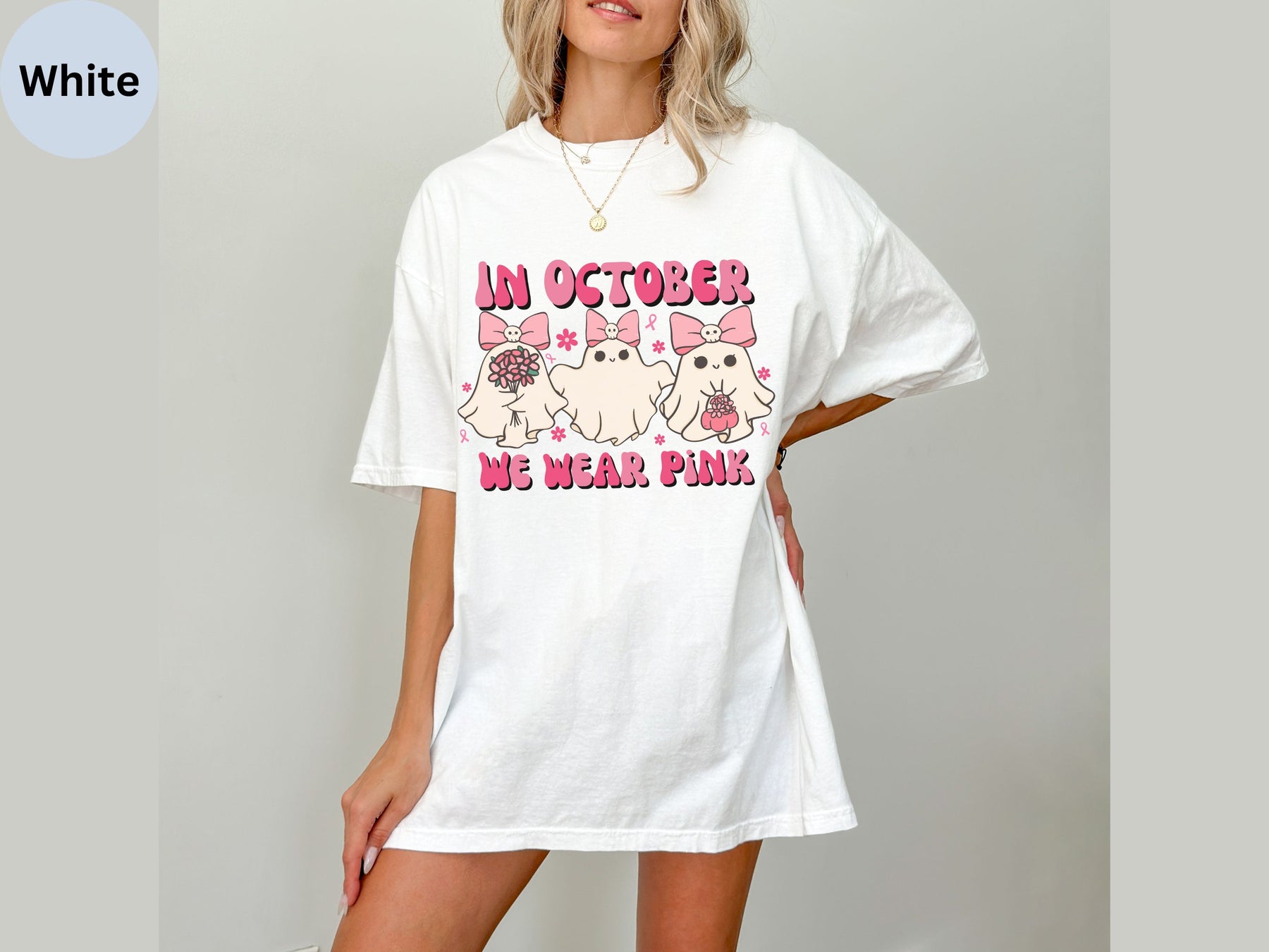 a woman wearing a white t - shirt that says i'm october we wear