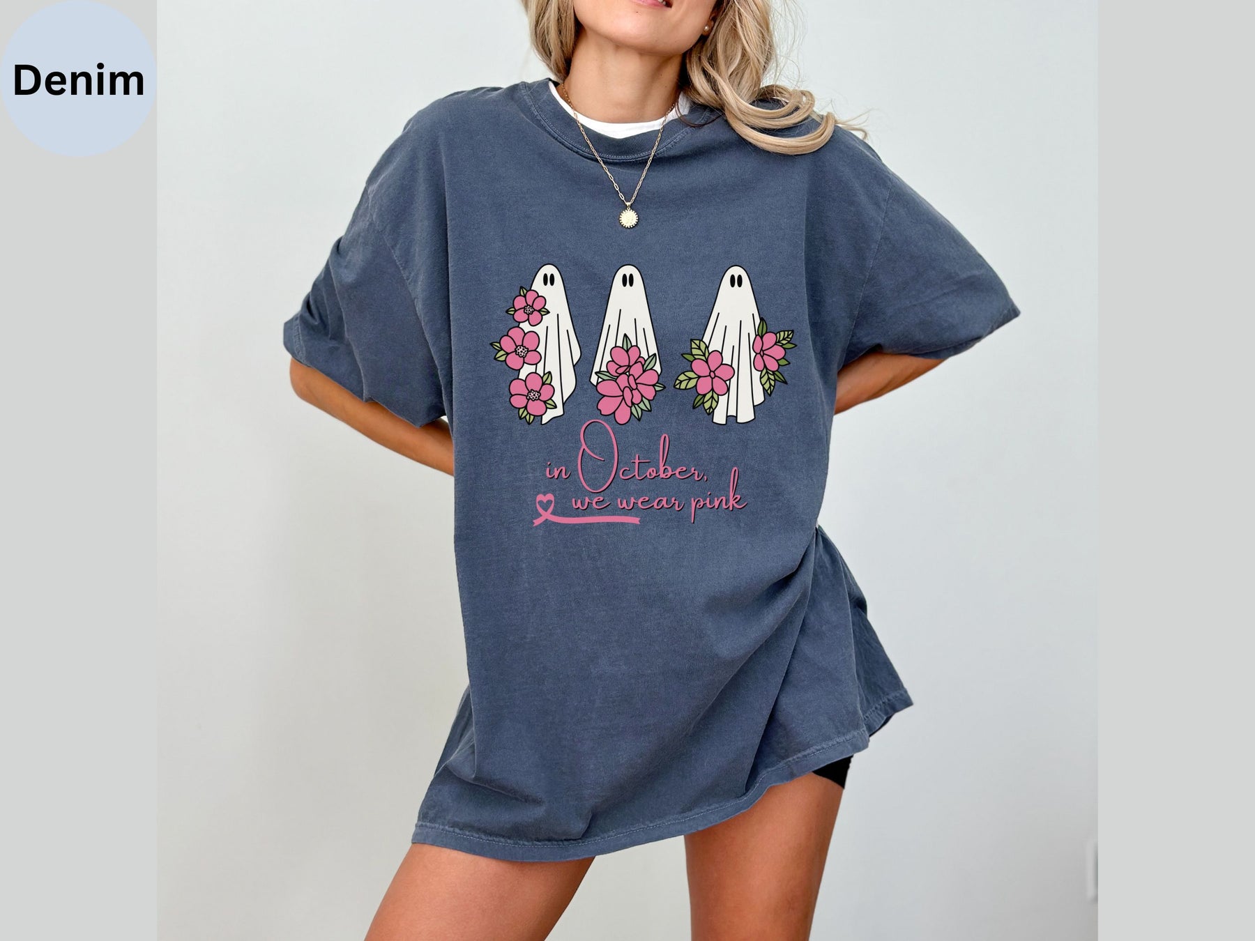 a woman wearing a blue t - shirt with flowers on it