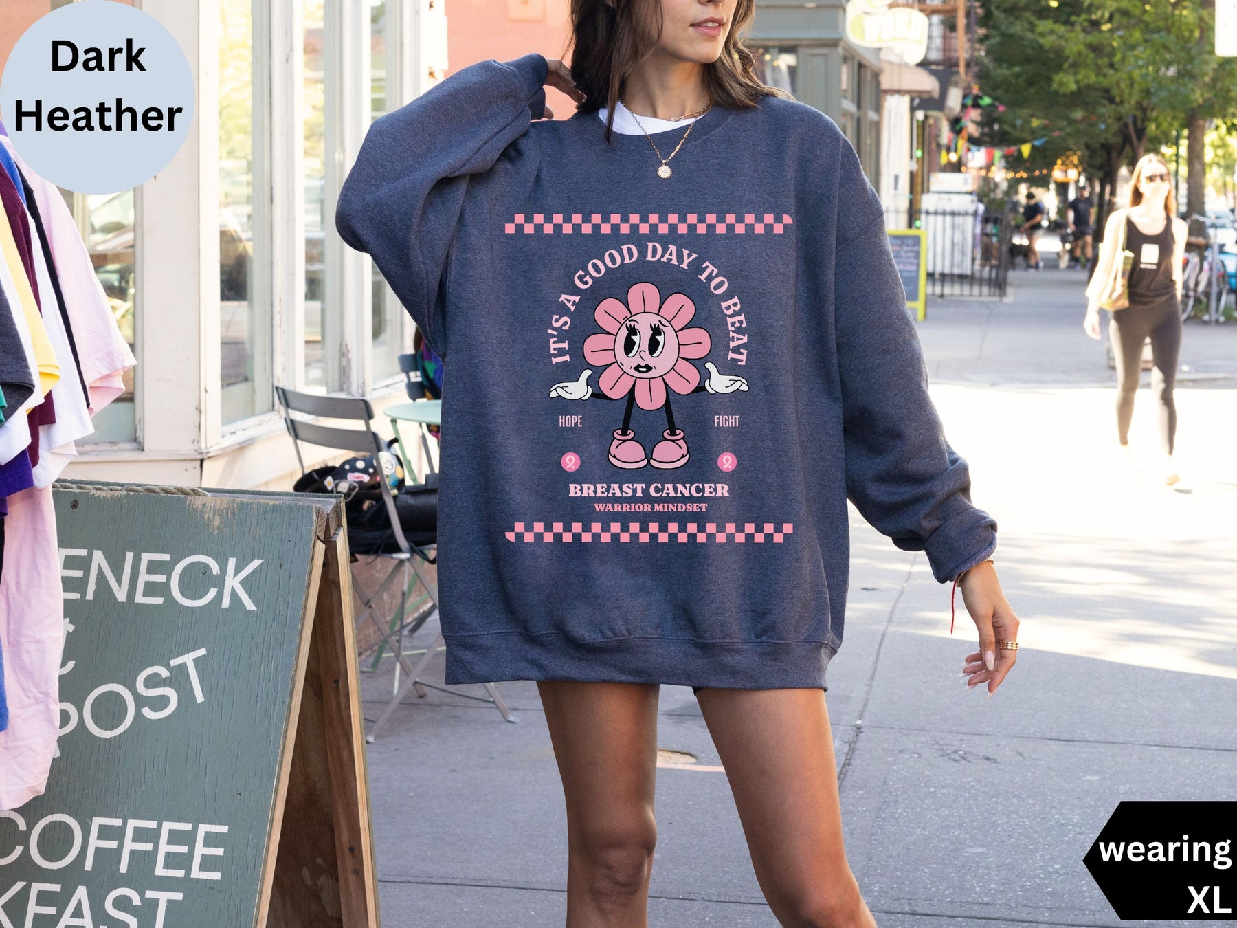 a woman is walking down the street wearing a sweatshirt