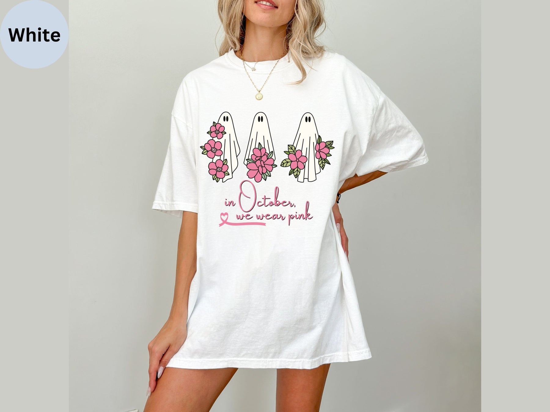 a woman wearing a white shirt with flowers on it