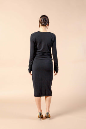Woman wearing long sleeve black sexy cashmere sweater dress back view