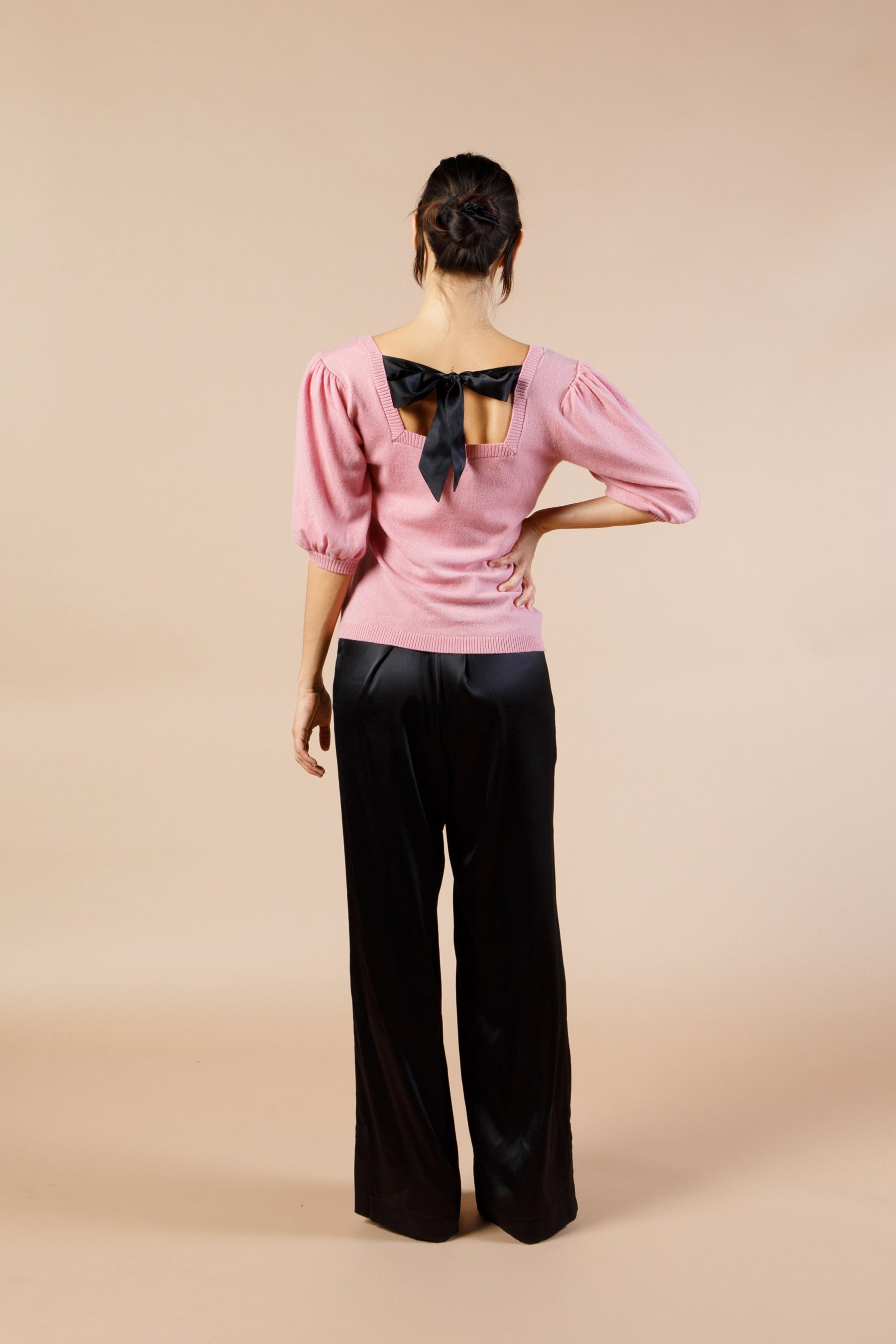 Woman wearing Pink Cashmere Sweater with Silk Bow and Short Sleeves