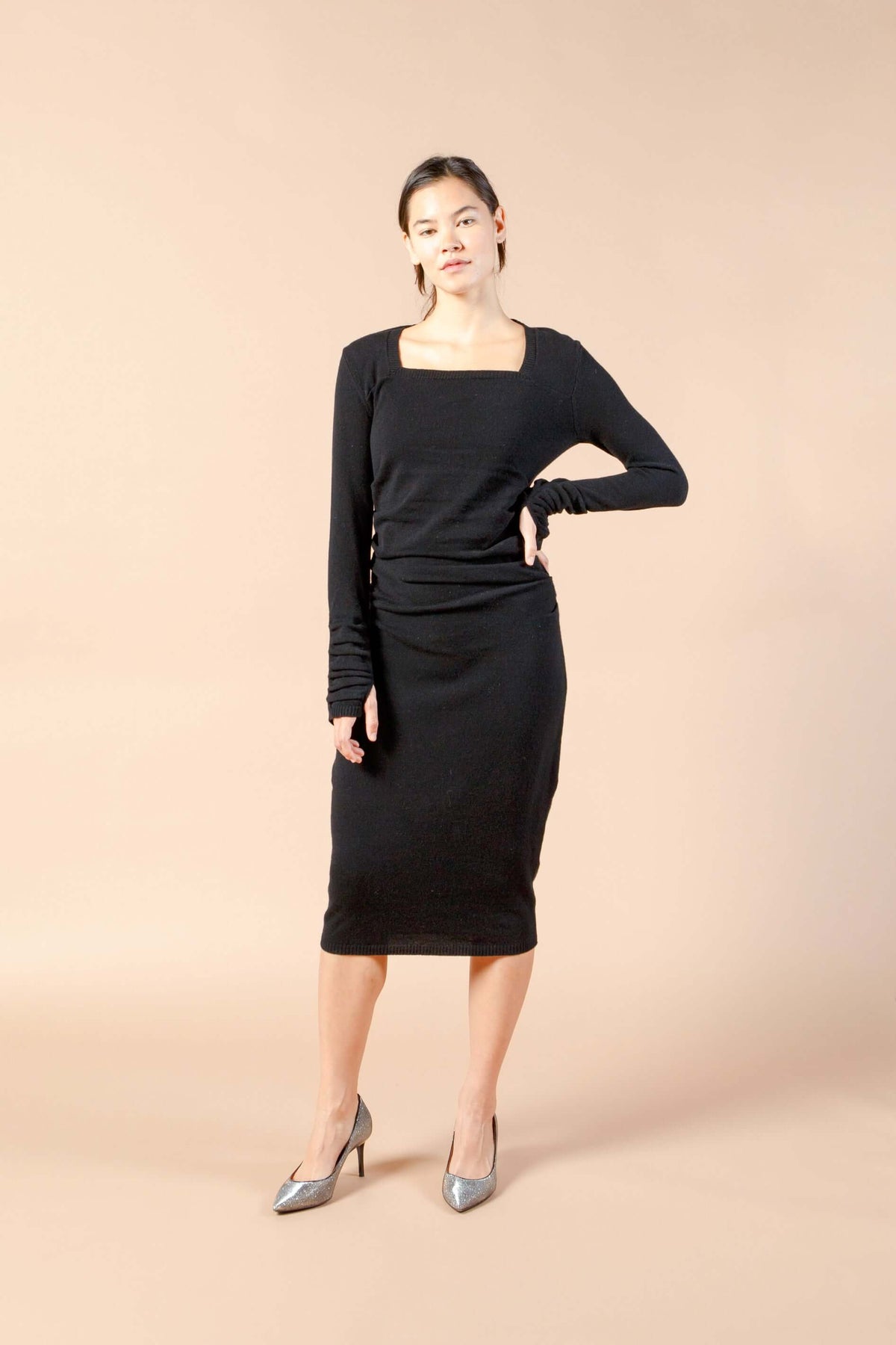 Woman wearing long sleeve black sexy cashmere sweater dress front view