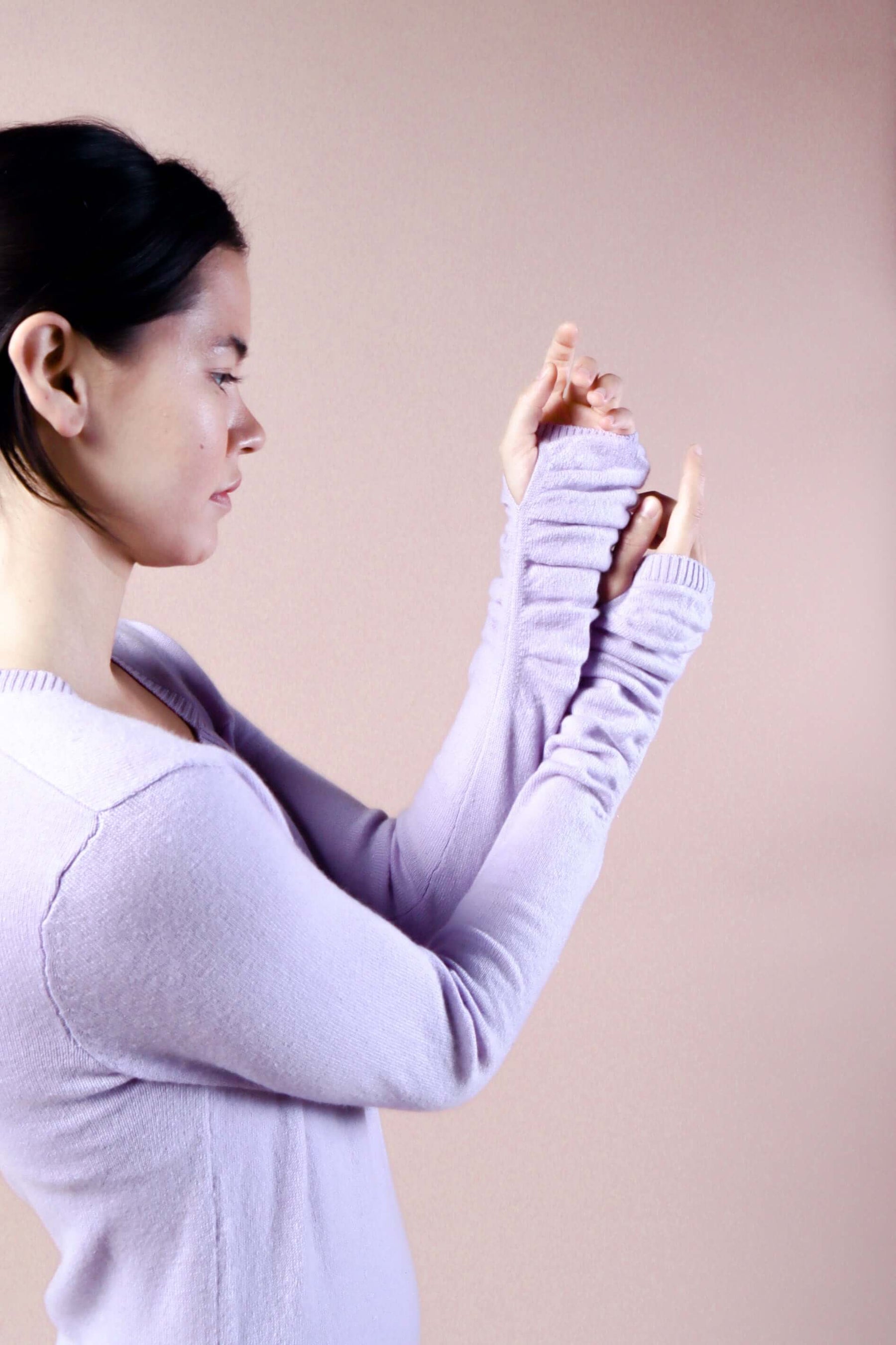  Woman wearing long sleeve lavender sexy cashmere sweater dress close up of sleeves and thumbholes at wrist