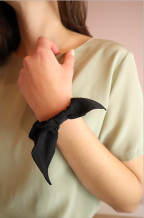 Woman wearing sustainable Black Silk Scrunchie with Bow
