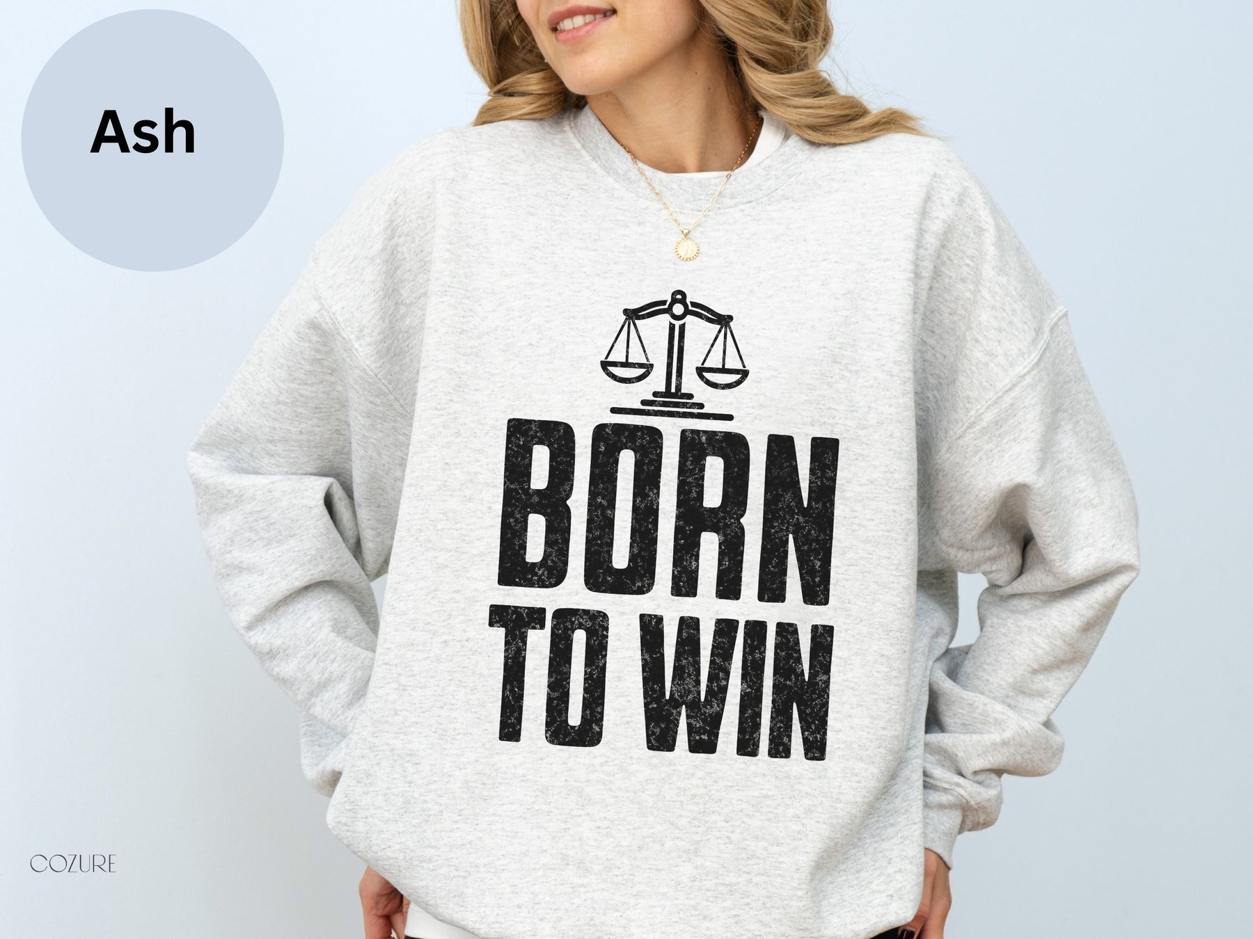 a woman wearing a sweatshirt that says born to win