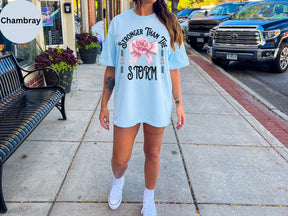 a woman standing on a sidewalk wearing a blue shirt and shorts