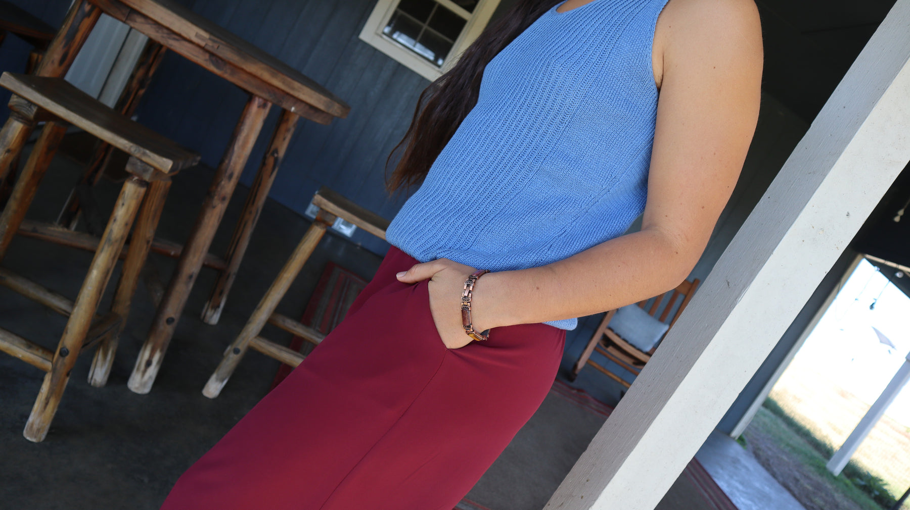 Pocket detail of Woman wearing sustainable red silk culottes ankle pants with wide leg