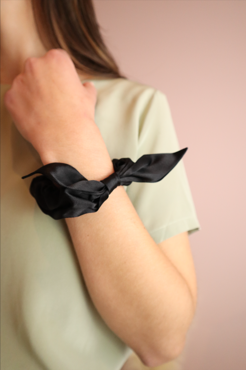 Woman wearing sustainable Black Silk Scrunchie with Bow